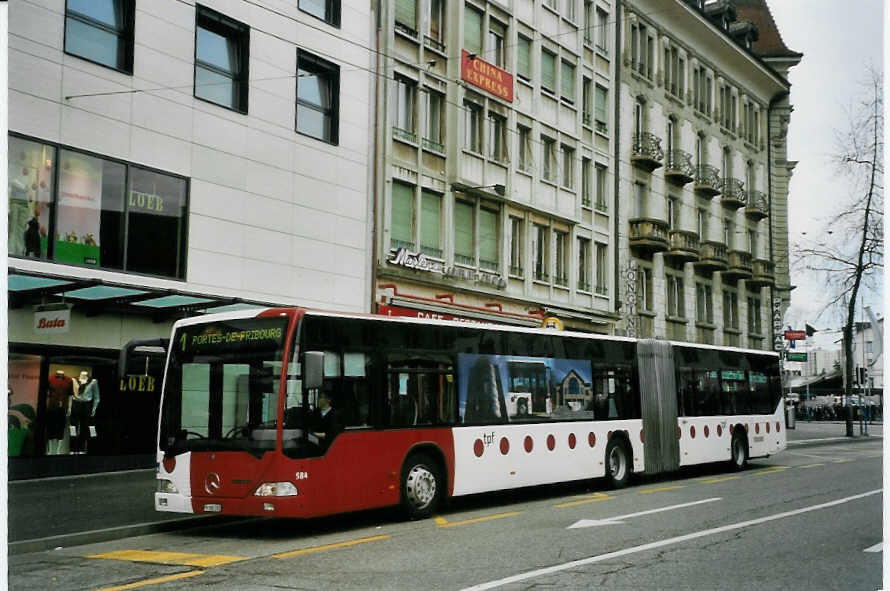 (066'112) - TPF Fribourg - Nr. 584/FR 300'392 - Mercedes am 21. M�rz 2004 beim Bahnhof Fribourg