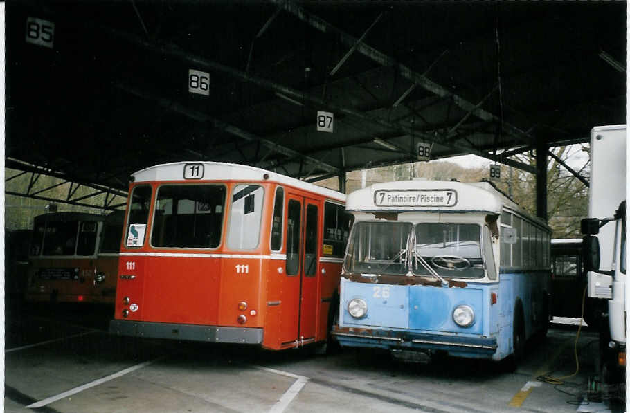 (066'232) - TPG Gen�ve (AGMT) - Nr. 111 - FBW/Hess + TC La Chaux-de-Fonds (AGMT) - Nr. 26 - Saurer/Haag Trolleybus (ex VBZ Z�rich Nr. 801 + 1) am 21. M�rz 2004 in Gen�ve, D�p�t TPG