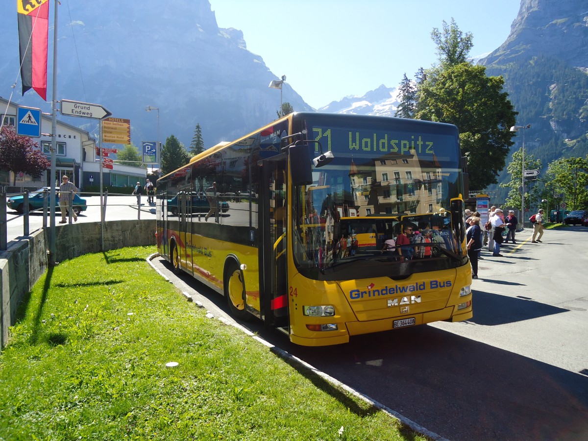 (134'675) - AVG Grindelwald - Nr. 24/BE 364'408 - MAN/G�ppel am 3. Juli 2011 beim Bahnhof Grindelwald