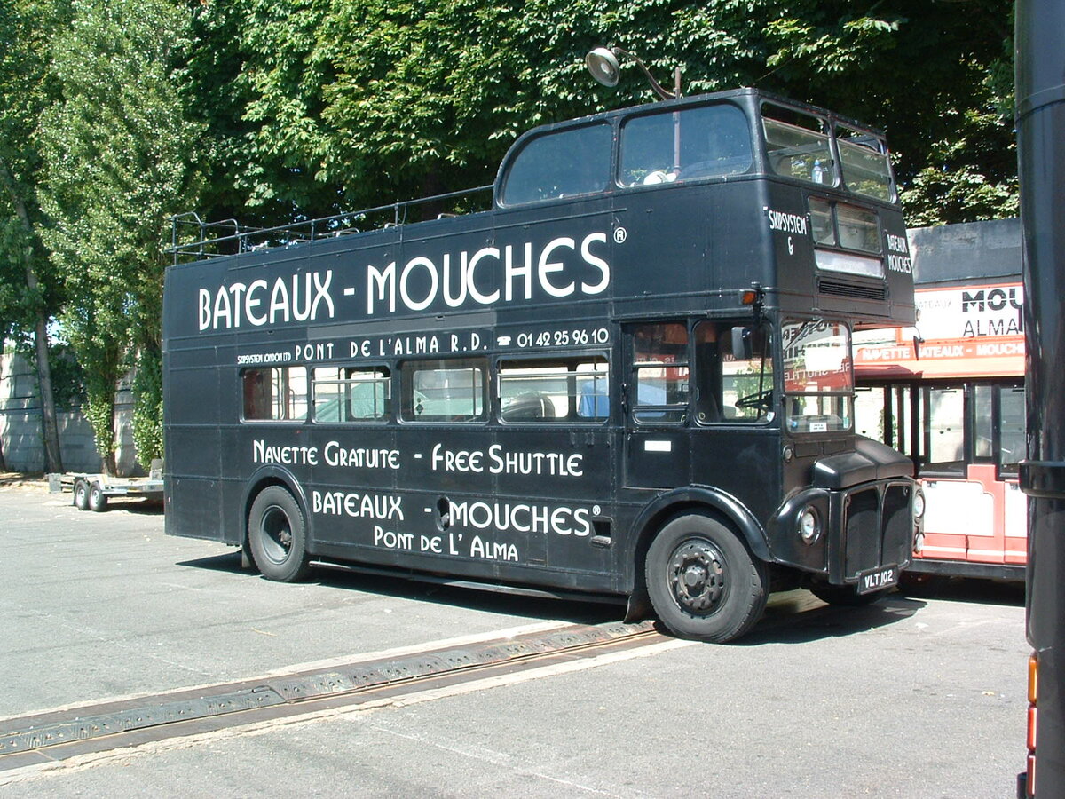 VLT 102
New in 1959 to London Transport, fleet number RM102, this AEC Routemaster with Park Royal H36/28R body, had hopped from one capital to another, being photographed in Paris, France in the ownership of Bateaux Mouches, a river boat sightseeing company, based at Port de la Conf�rence, Pont de l’Alma.  It was converted to open top after export.

As can be seen in this photograph, taken on 14th July 2003, it still carries its' UK registration, so it most probably is used as a publicity asset.

Incidentally, Oxford Diecast made a model based on this bus.